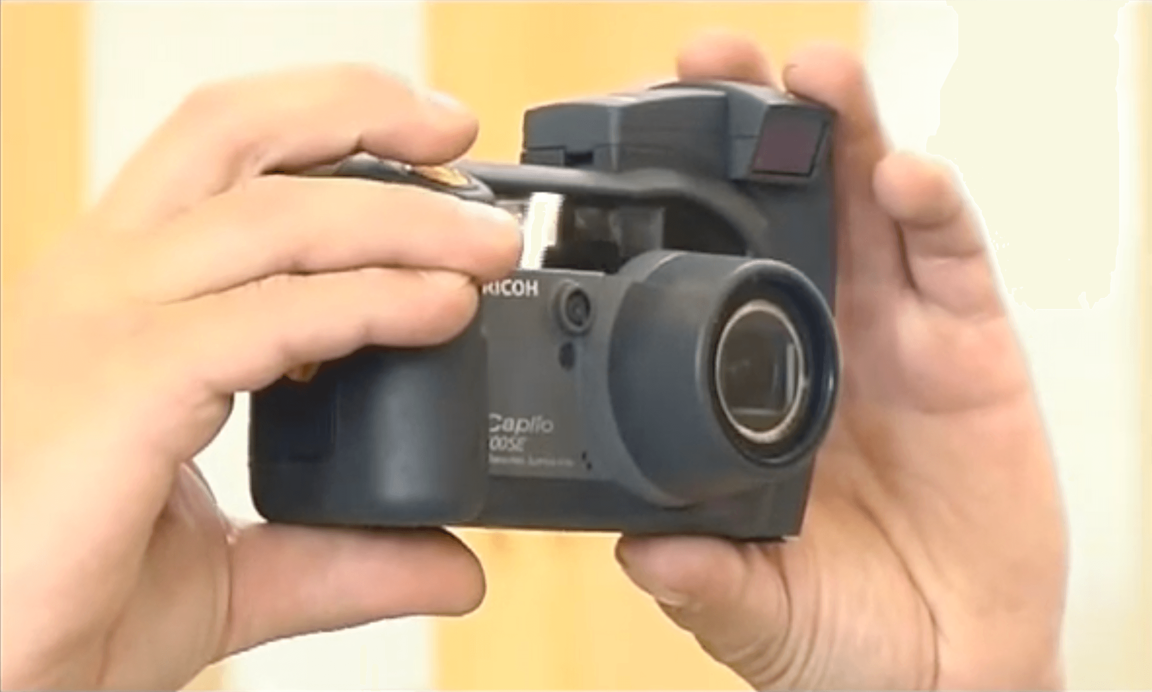 A Ricoh camera with its barcode scanning attachment being used in the field.